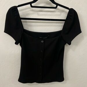 Reformation top button front detail.